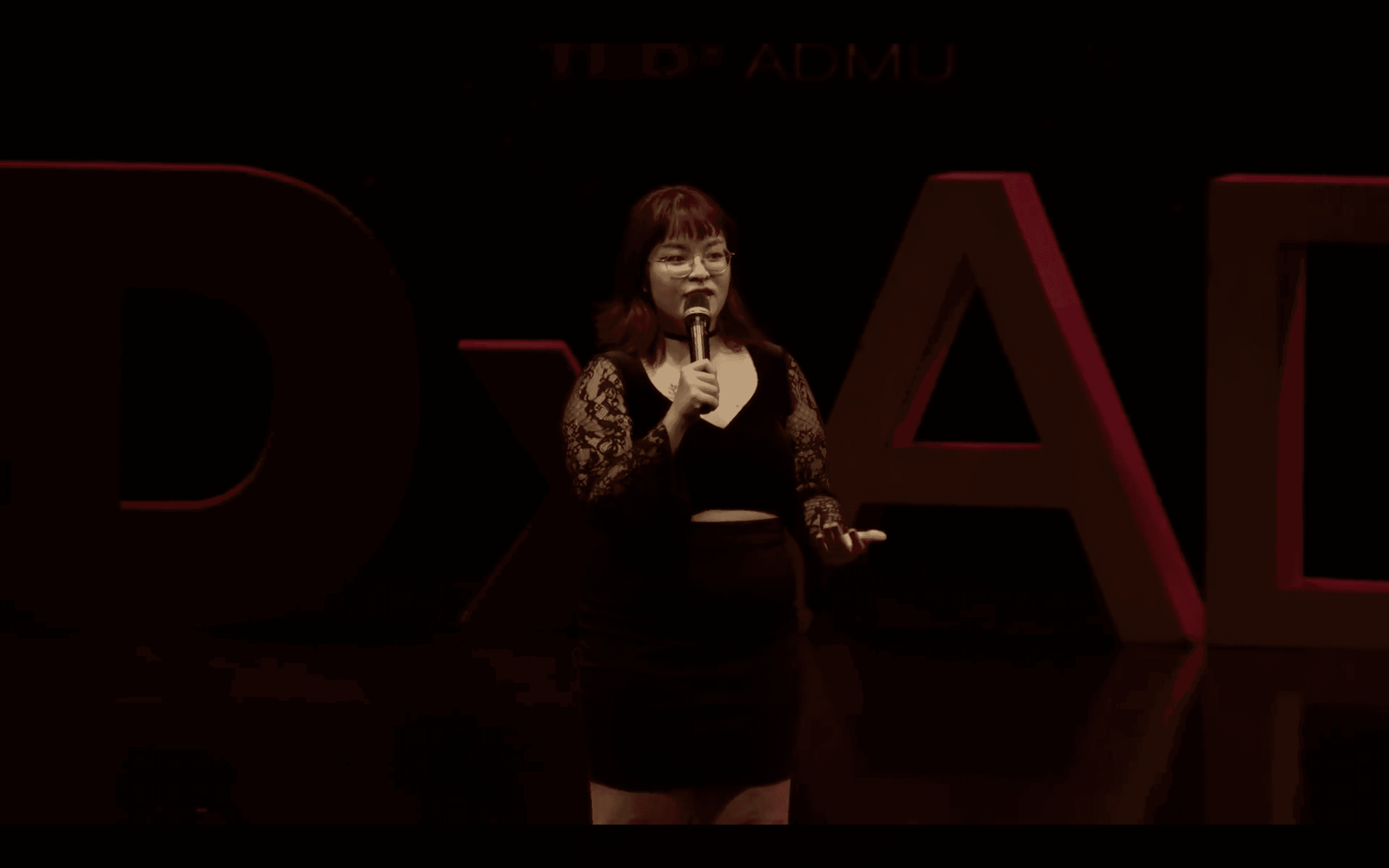 Justine Danielle Reyes speaking on the TEDxAteneodeManilaU stage.